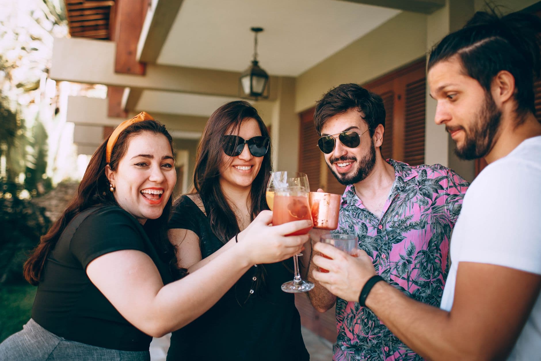 Friends toasting with cocktails and canned drinks — data that drives the next sale